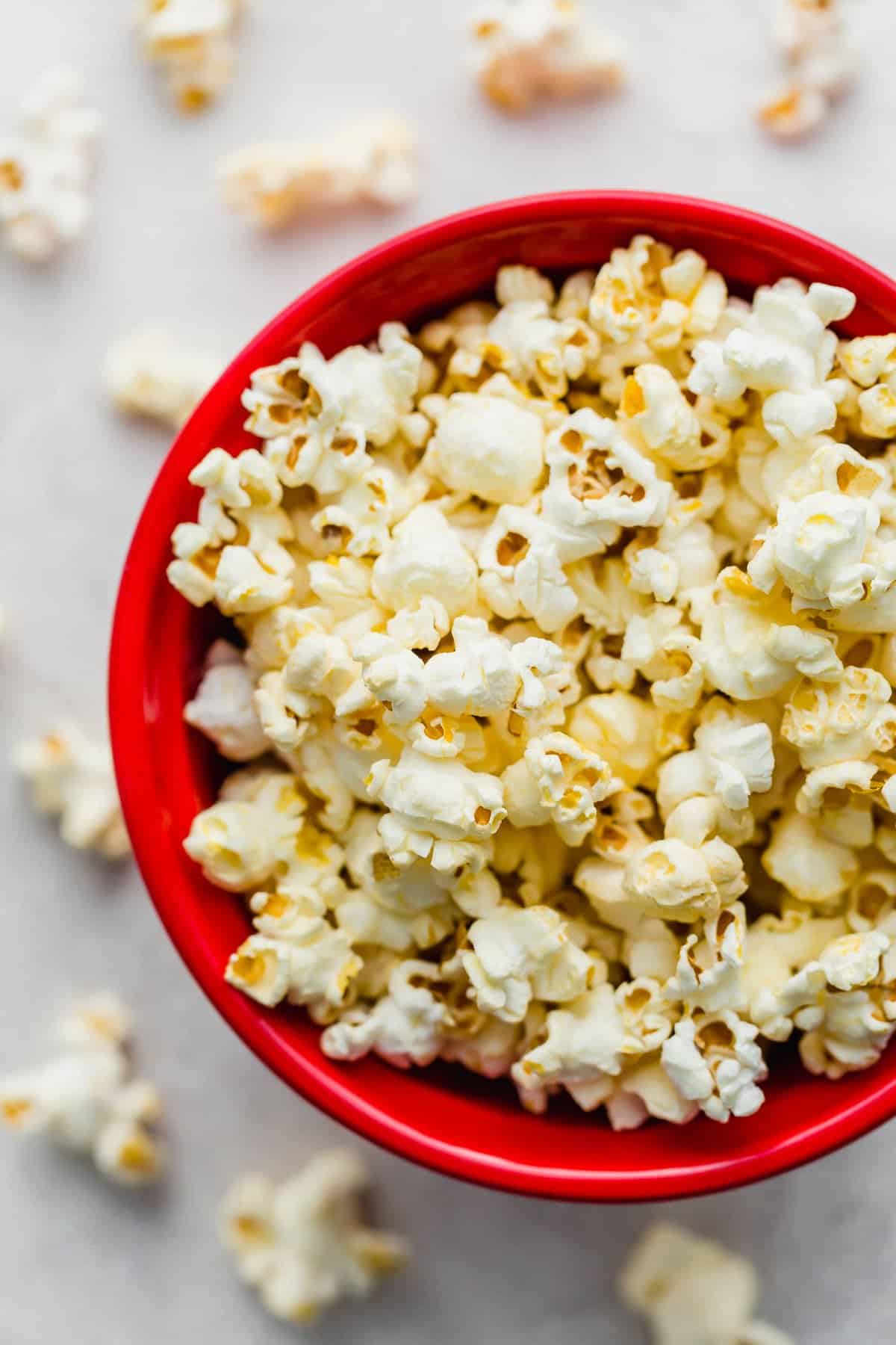 Overhead photo of Movie Theater Popcorn in a red bowl on a white background.