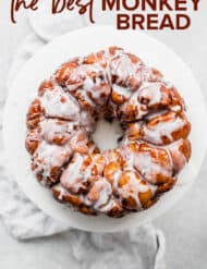 A cake stand with a glazed monkey bread recipe on it.