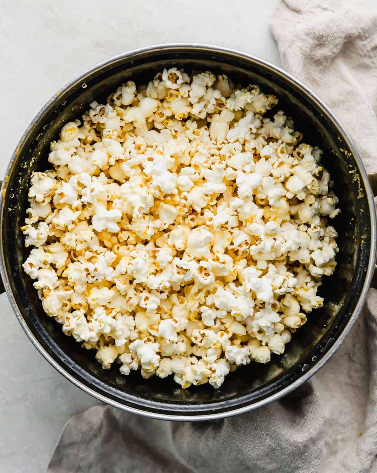 A black pot with Movie Theater Popcorn in it.