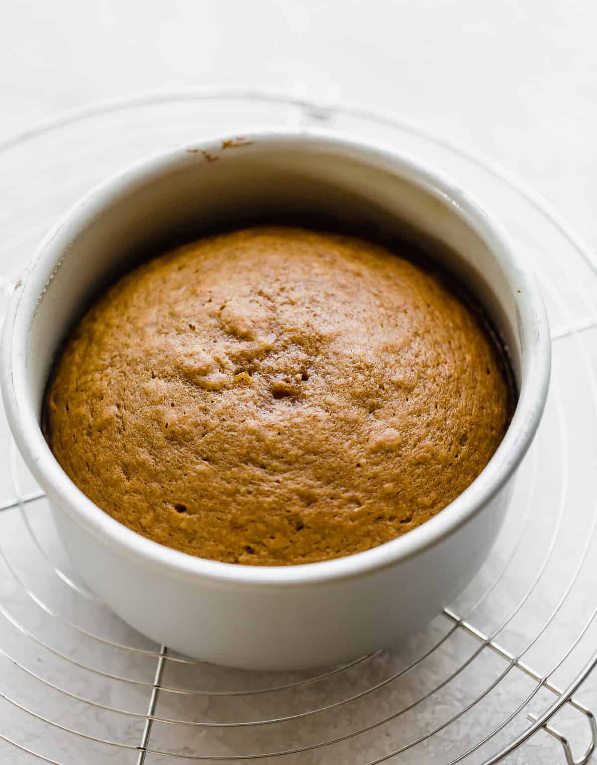 A baked Pumpkin Cake in a round cake pan.