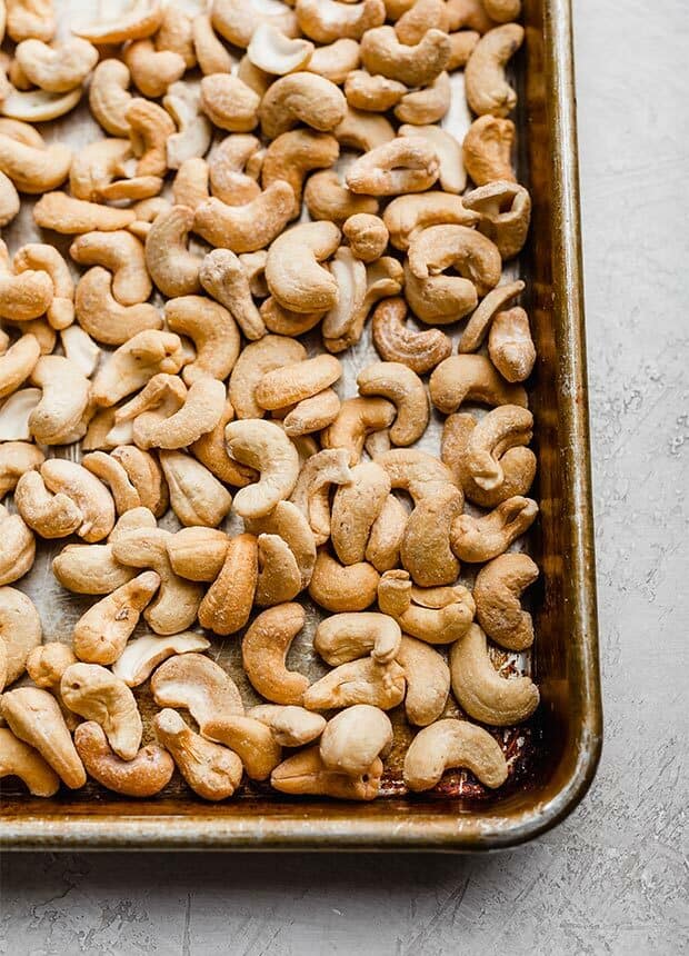 Salted cashews on a baking sheet.