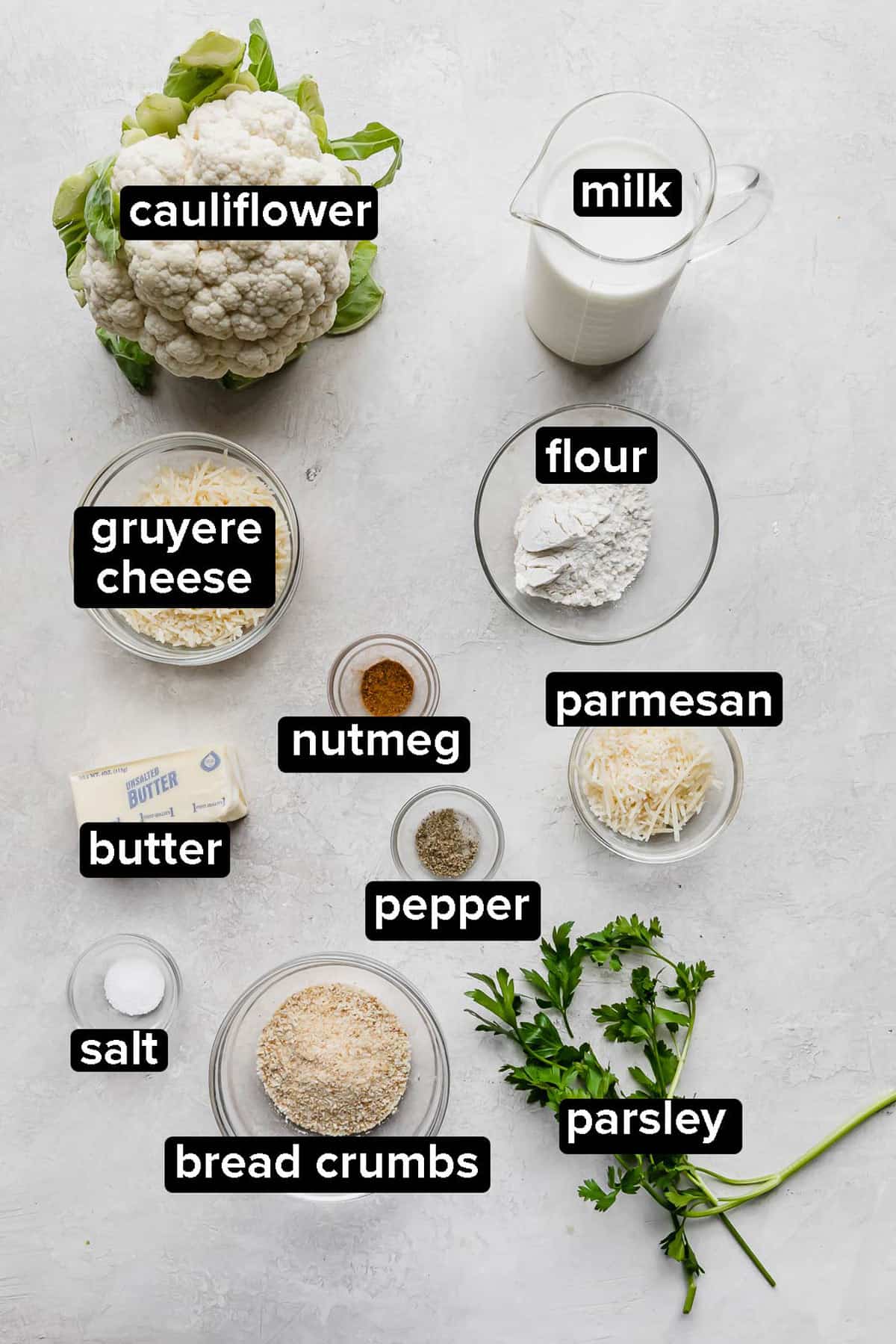 Cauliflower Gratin ingredients on a gray background.