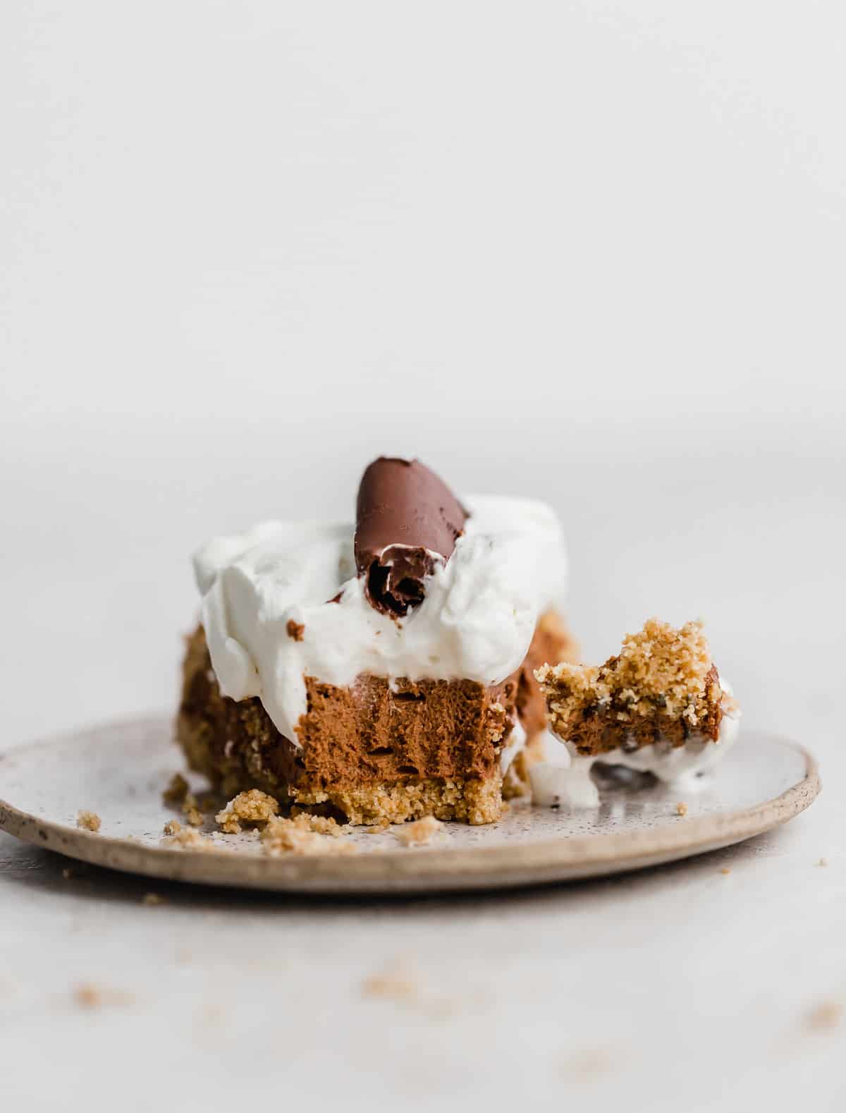 A slice of French Silk Pie on a plate against a white background.