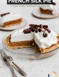 A chocolate pie in a graham cracker crust with the words, "French Silk Pie" written in white font, with the words, "a must-make Thanksgiving dessert" in brown font below the title.