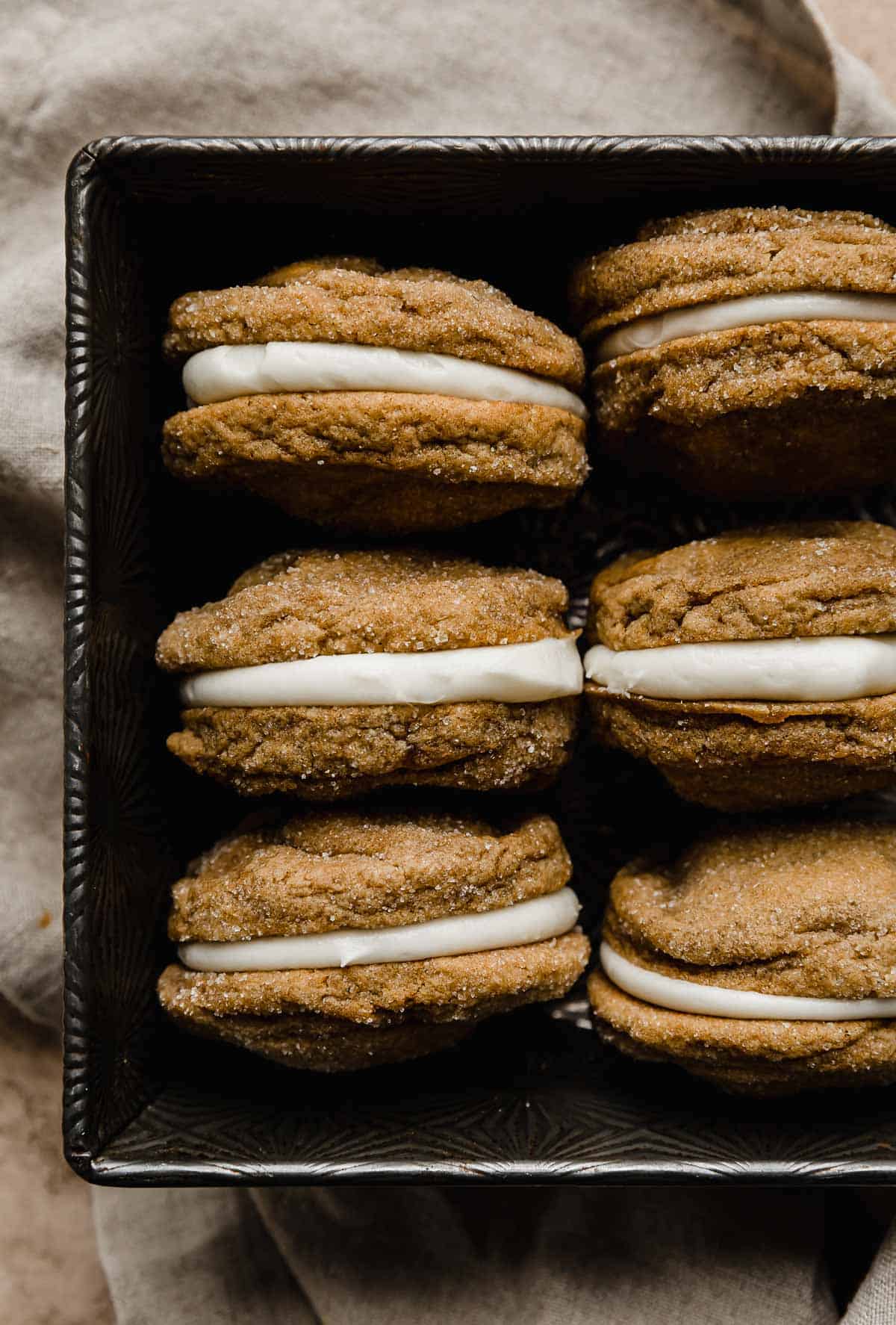 Gingerbread Sandwich Cookies in a bronze baking dish.