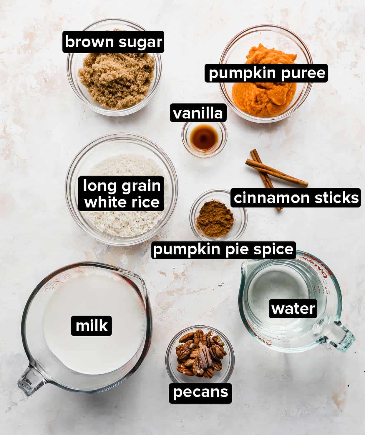 Pumpkin Rice Pudding ingredients on a white background.