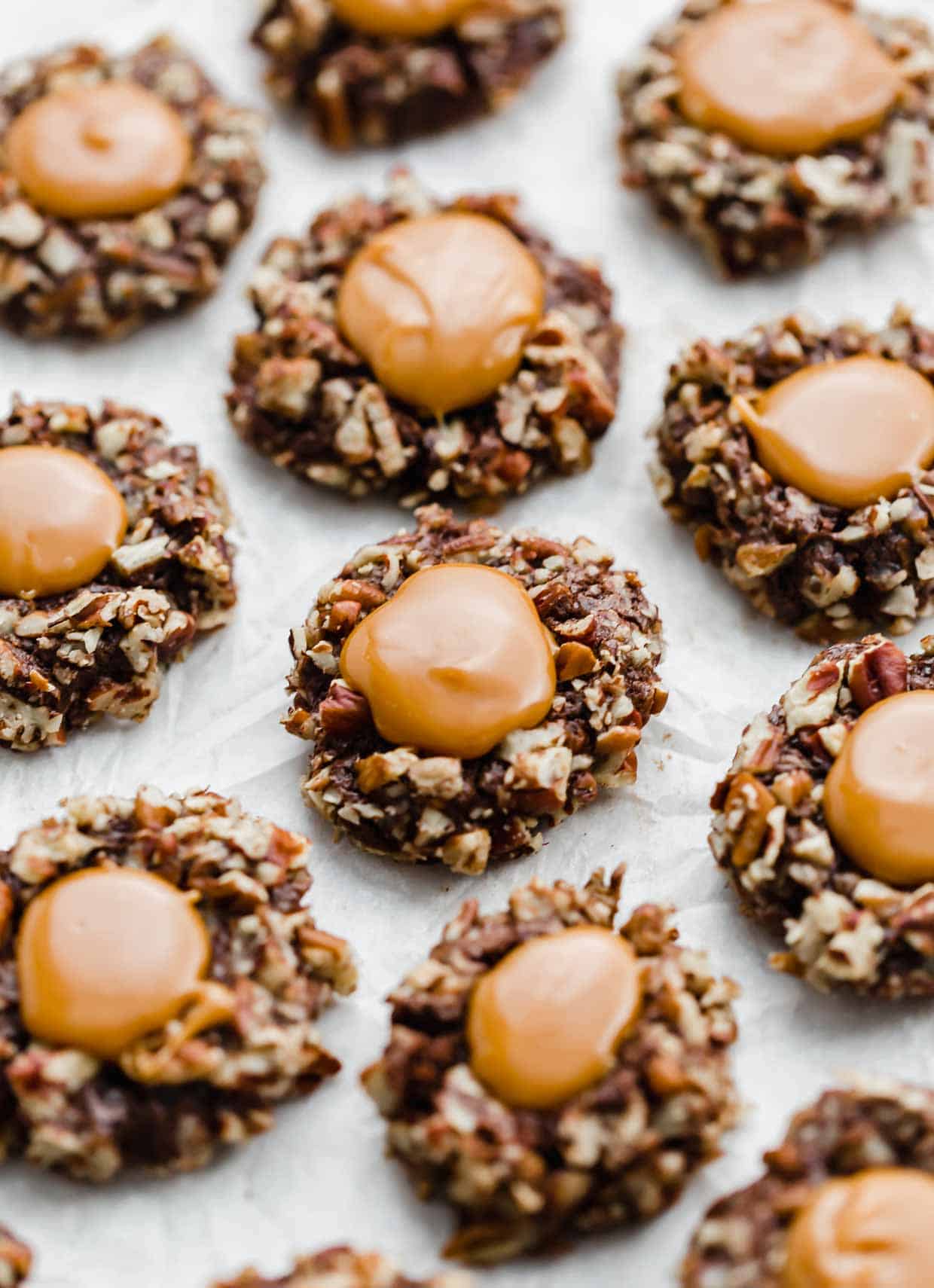 Melted caramel in the center of chocolate pecan covered cookies. 