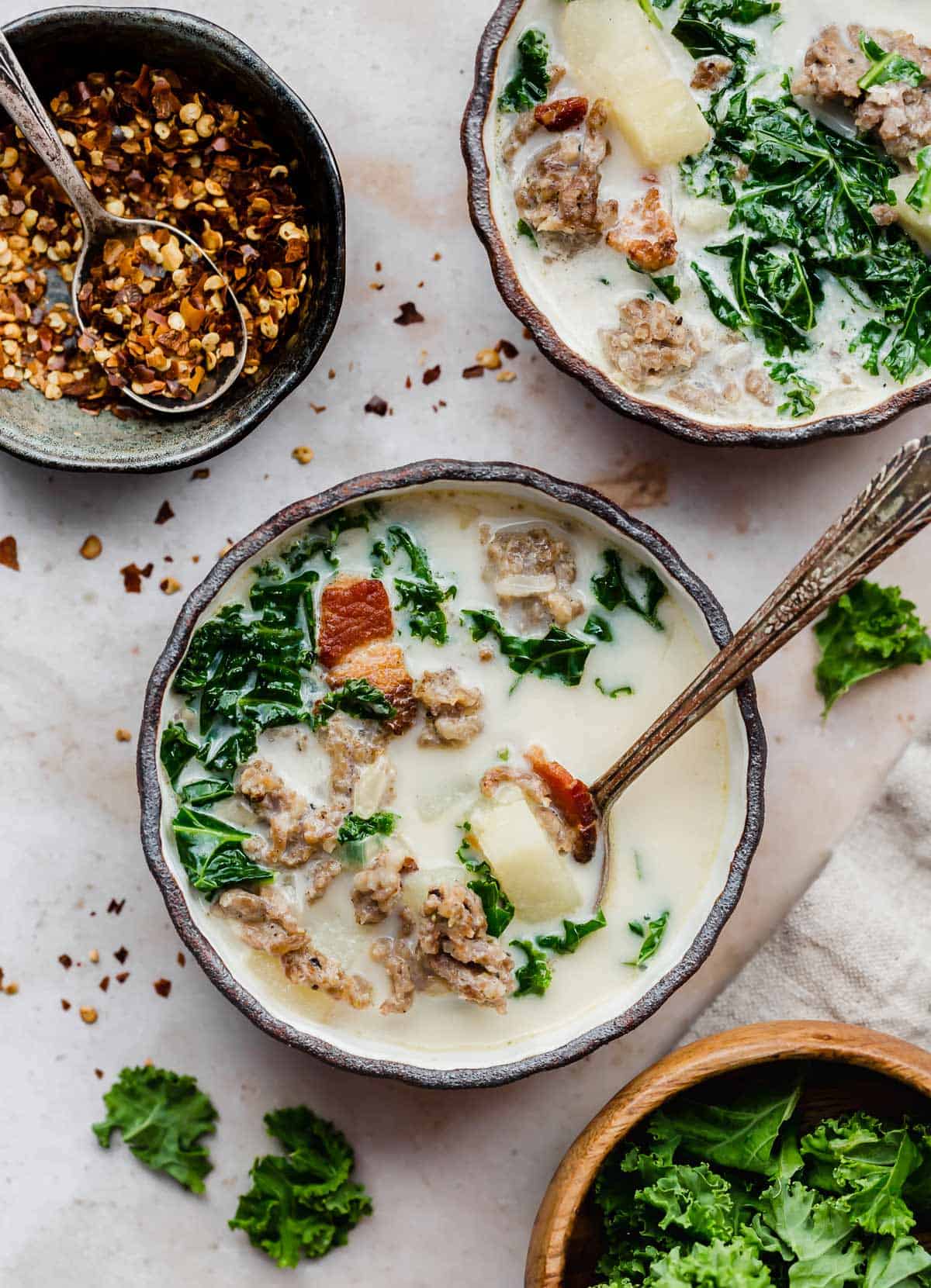 A black rimmed bowl filled with homemade Olive Garden Zuppa Toscana Soup.