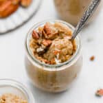 Pumpkin Rice Pudding in a glass jar on a white background.