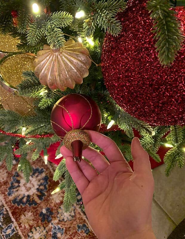 A red and gold Christmas tree ornament.