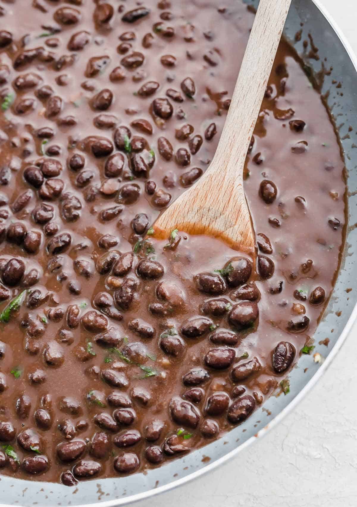 Cafe Rio Black Beans in a gray skillet.