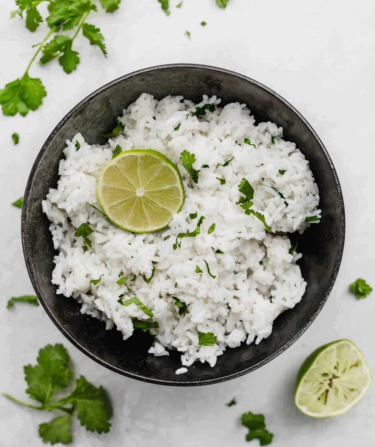 A black bowl with Cilantro Lime Rice in it, on a white background.
