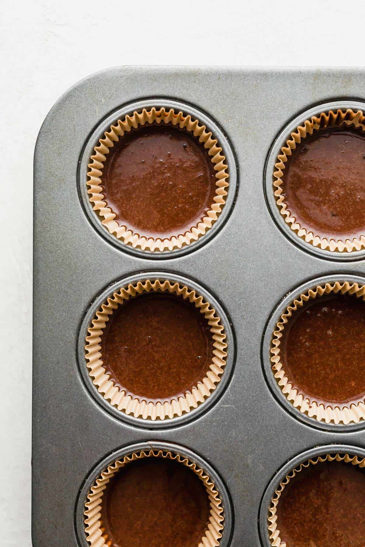 German Chocolate Cupcake batter in tan cupcake liners.