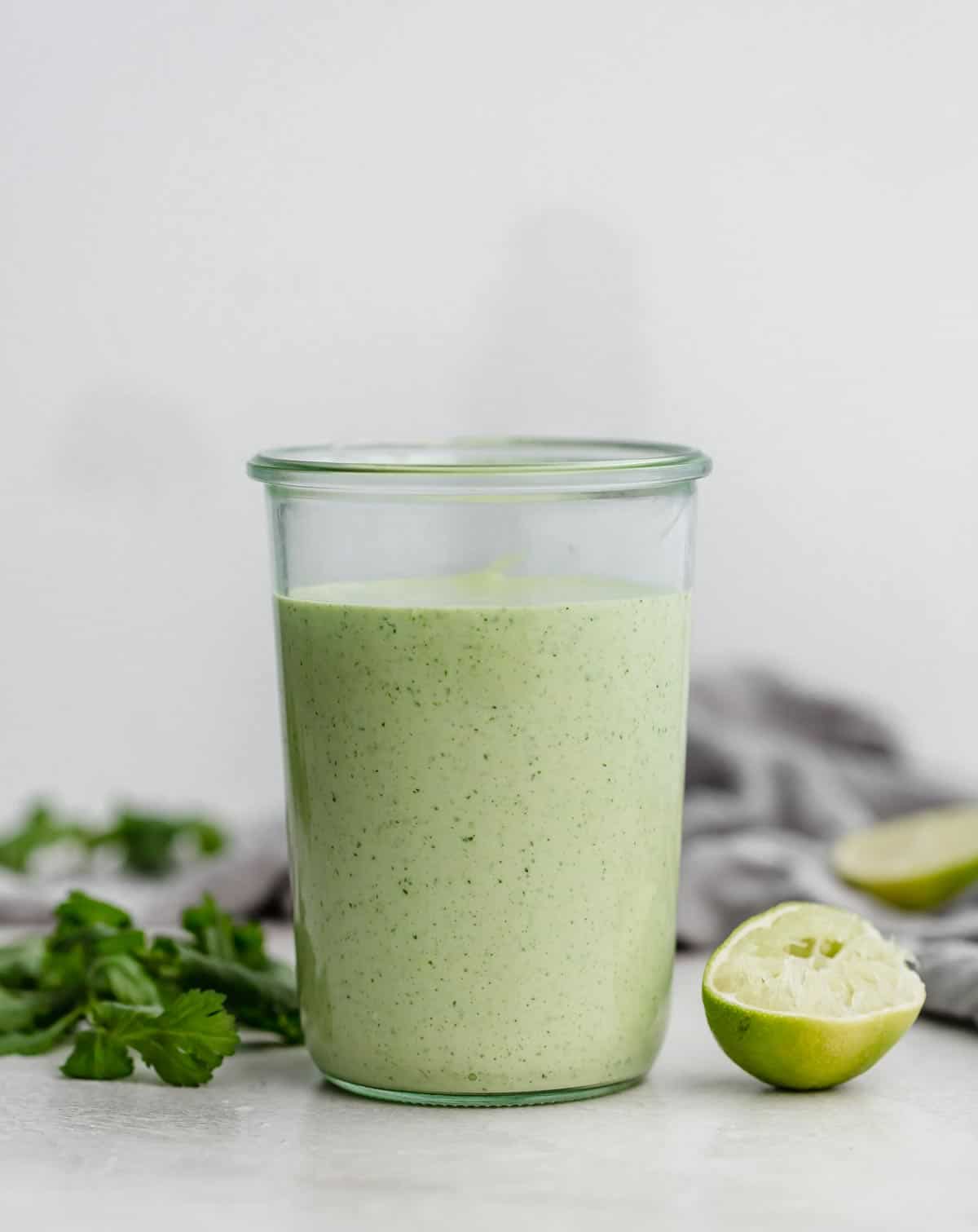 Cafe Rio Cilantro Lime Dressing in a jar against a light gray background.