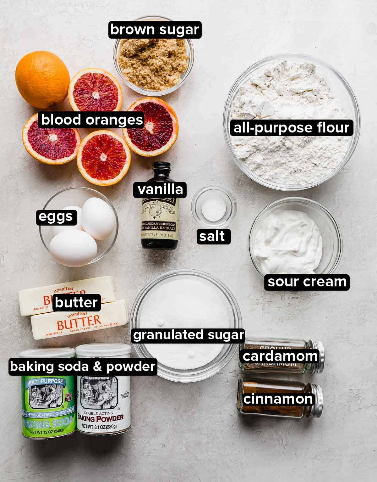 Blood Orange Bundt Cake ingredients portioned into glass bowls on a light gray background.
