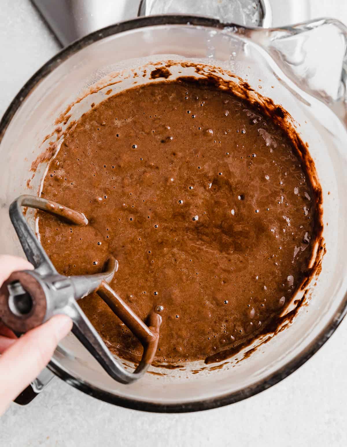 Moist Chocolate Cake batter made with oil in a glass bowl.