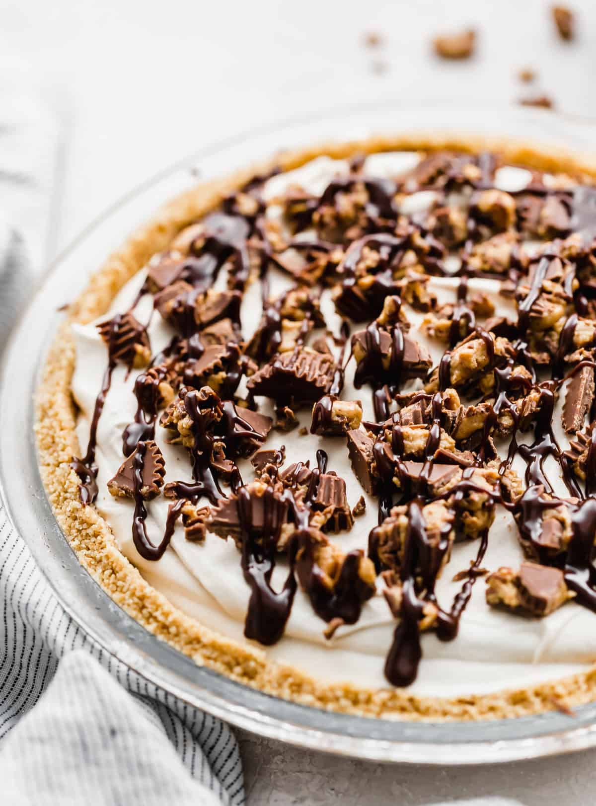 A Reese's peanut butter cup topped No-Bake Peanut Butter Pie.