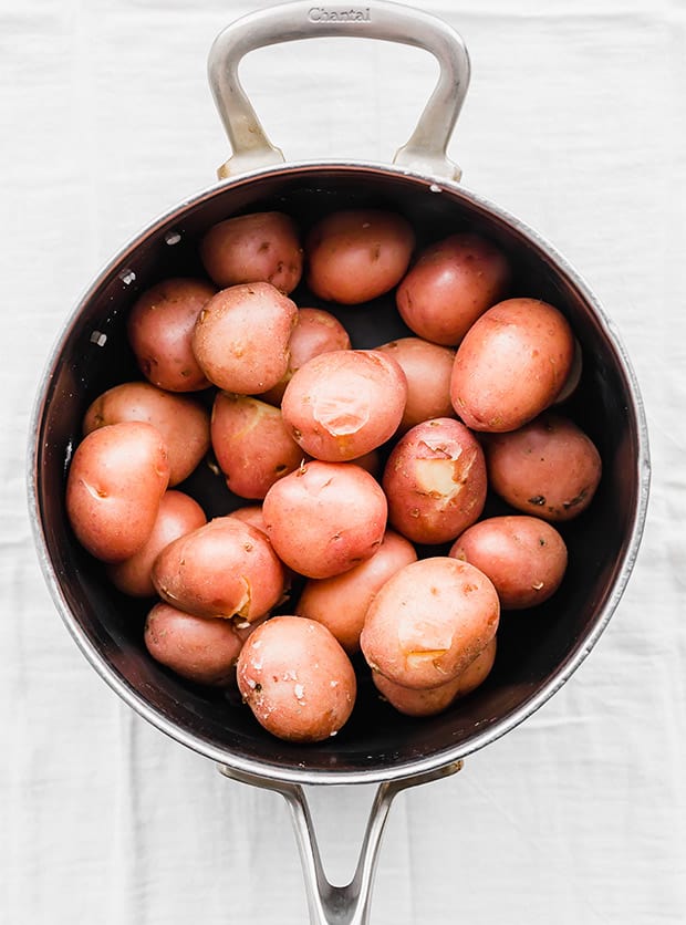 Boiled red potatoes in a pot.