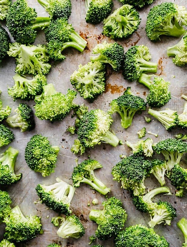 Raw broccoli on a baking sheet.