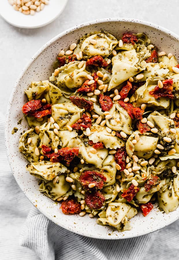 Pesto tortellini topped with sun dried tomatoes and pine nuts.