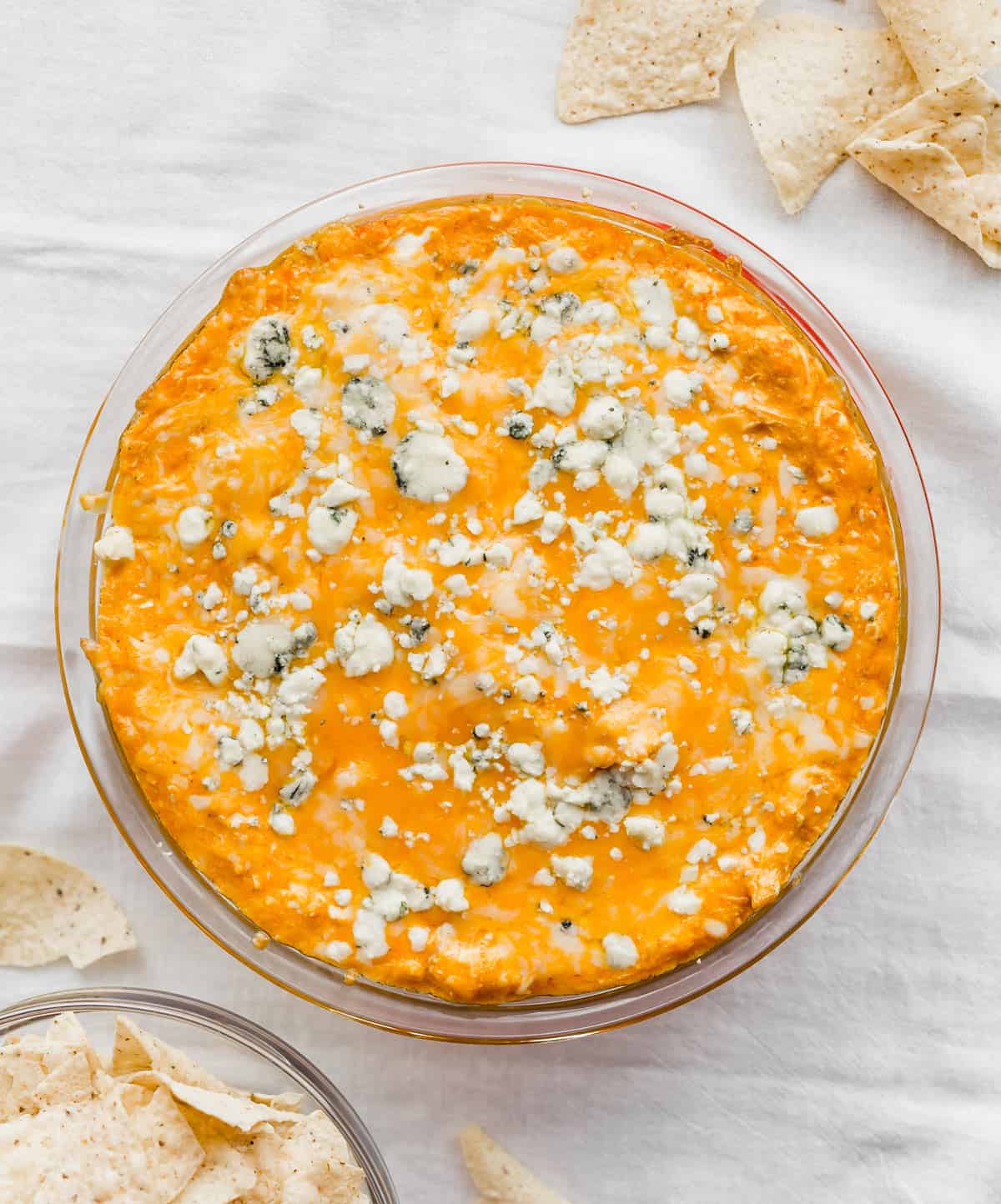 Buffalo Chicken Dip with Blue Cheese on a white napkin surrounded by flour tortilla chips.