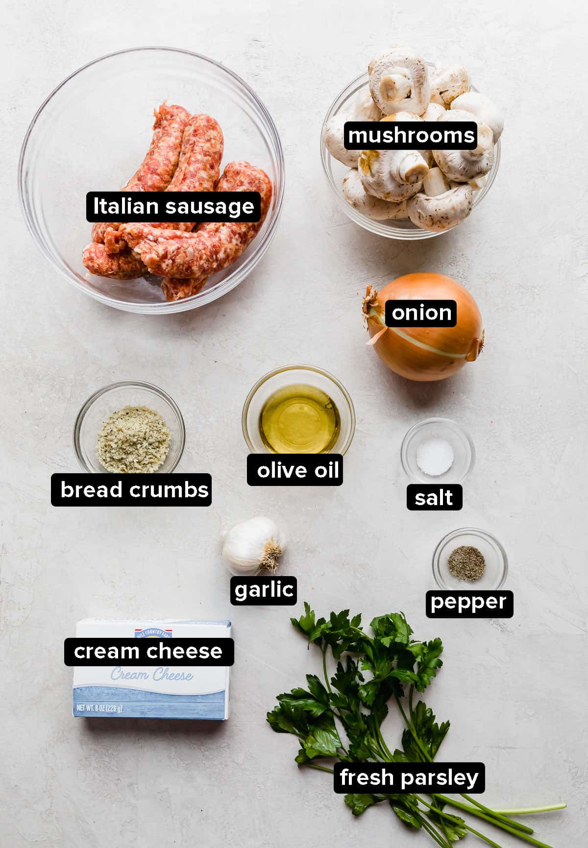 Italian Sausage Stuffed Mushrooms ingredients laid out on a gray background.