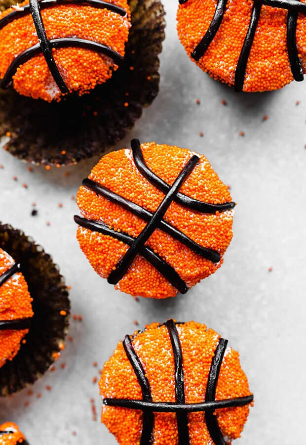 A close up photo of chocolate cupcakes decorated to look like basketballs.