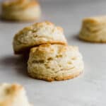 Two easy buttermilk biscuits on a gray background.