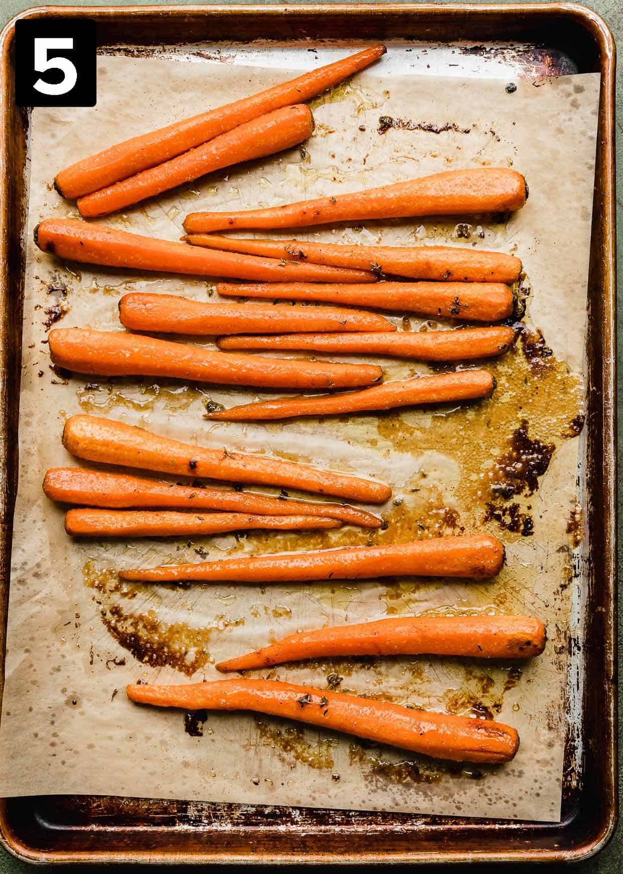 Brown sugar roasted carrots on a baking sheet. 
