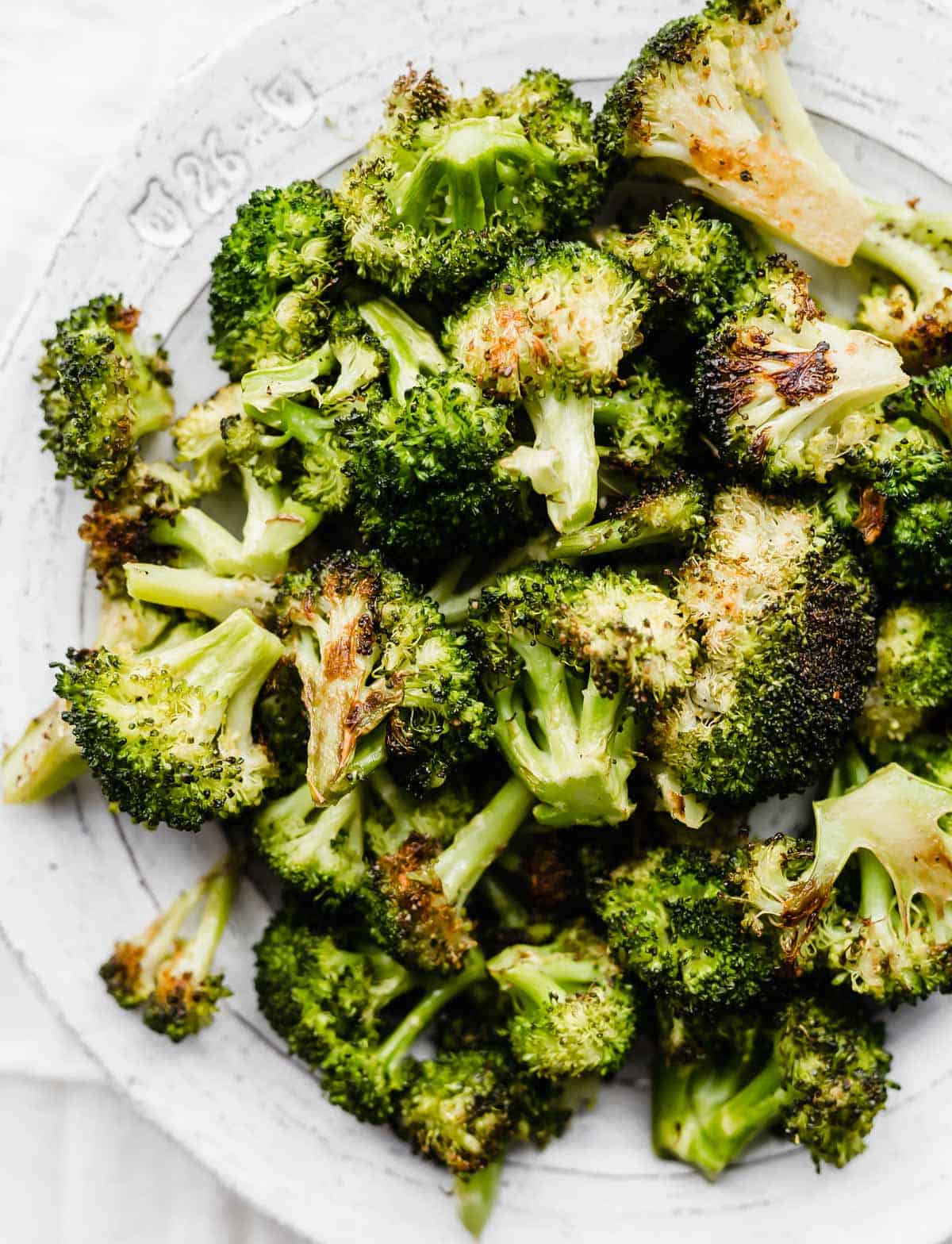 Oven Roasted Broccoli on a white plate.