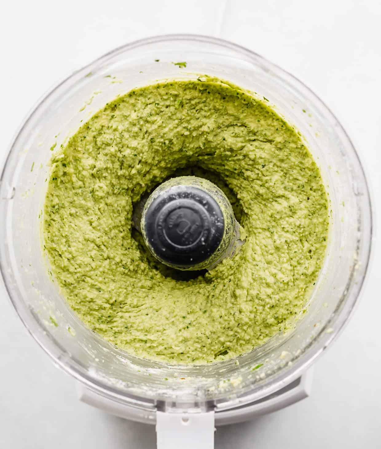 Pureed green falafel mixture in a food processor.