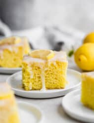 A slice of lemon jello cake topped with a lemon glaze.