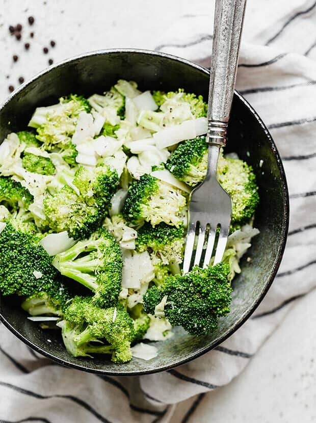 A broccoli floret in a forks tines.