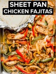 A sheet pan full of chicken fajitas and seasonings.