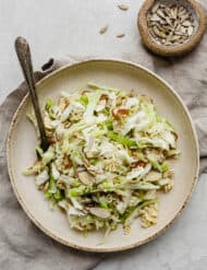 Overhead photo of cabbage salad on a large plate.