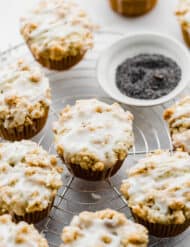 Lemon poppy seed muffins with a crumb topping and lemon glaze.