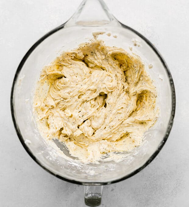 A stand mixer bowl full of lemon poppy seed muffin batter.