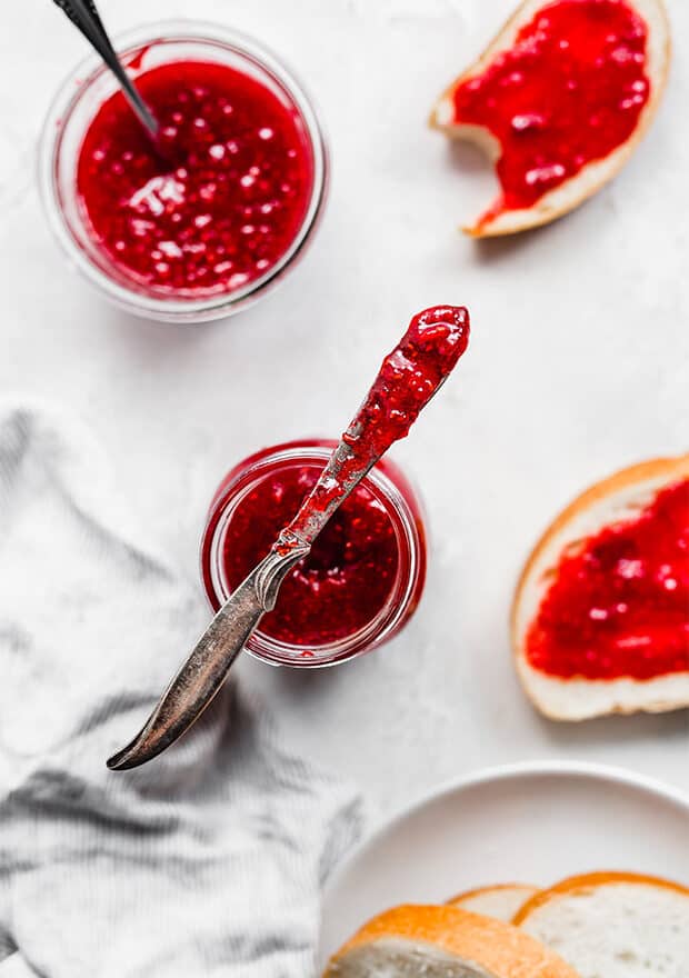 A knife covered in raspberry freezer jam.