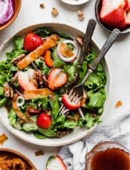 Two forks in a bowl of Strawberry Spinach Salad.
