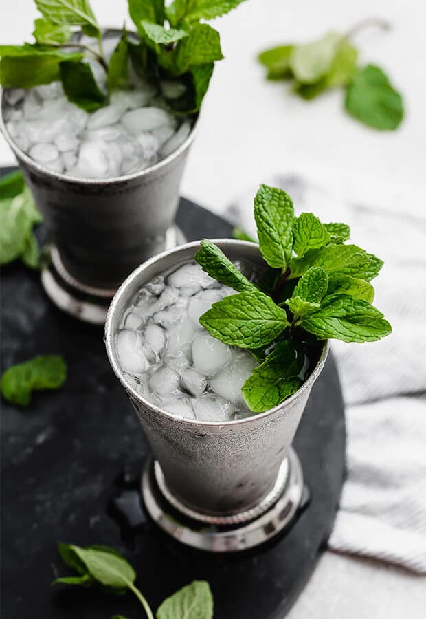 A virgin mint julep in a silver cup with a sprig of mint. 