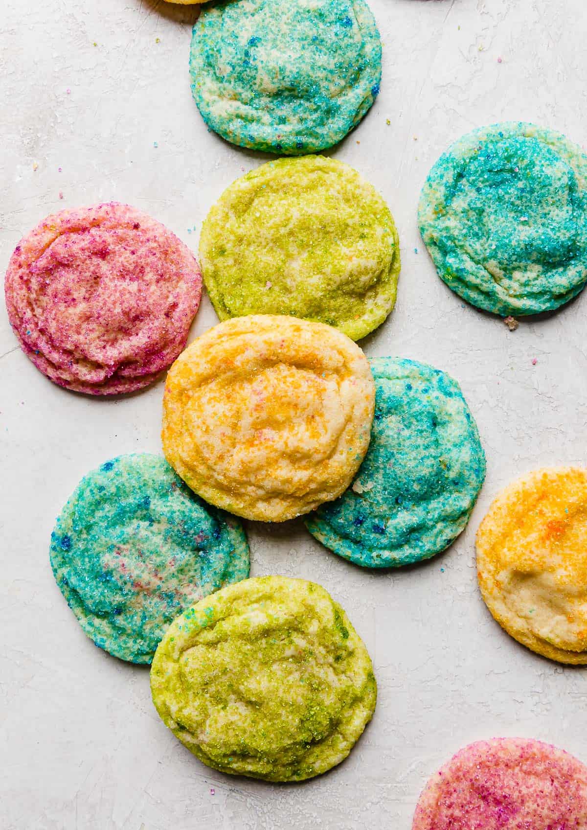 Colorful sugar coated cookies on a light grey background. 