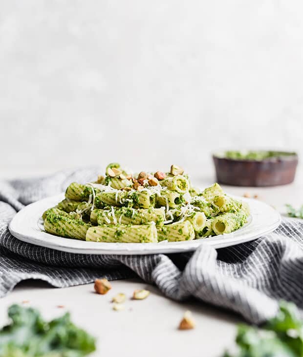 Side view of Kale Pesto Pasta on a white plate. 