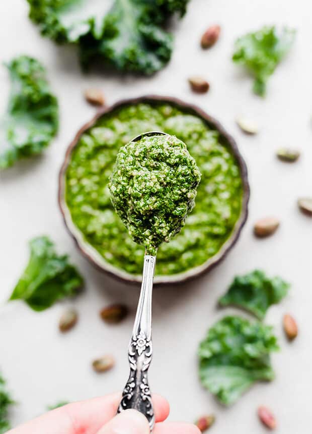 Kale pesto on a silver spoon.