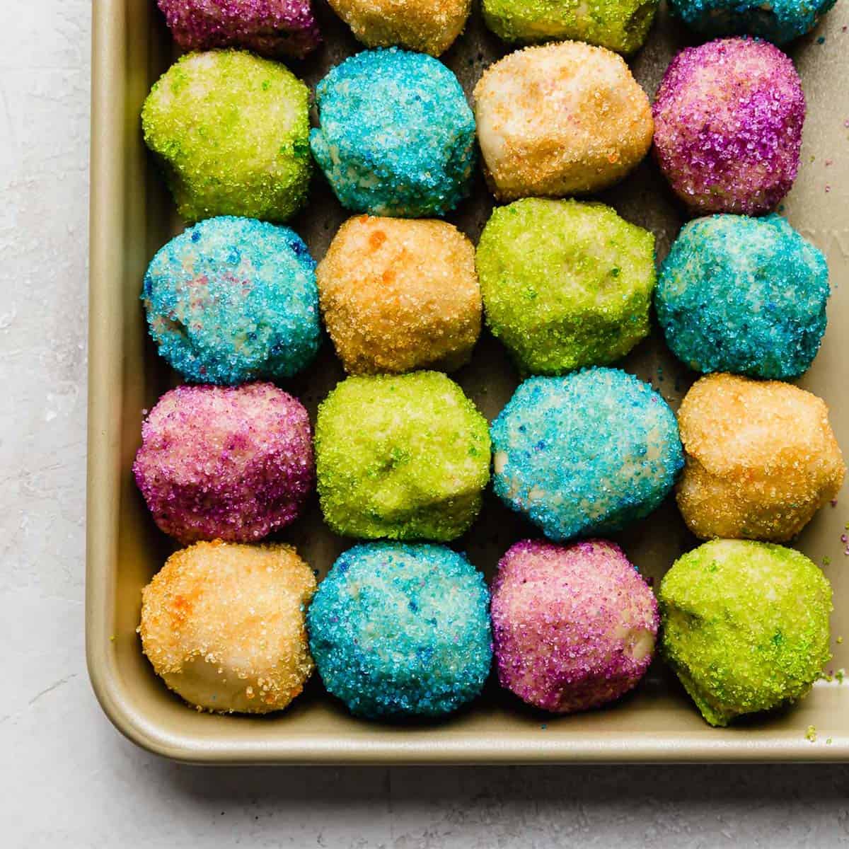 Sugar cookie dough balls coated in colored sugar.