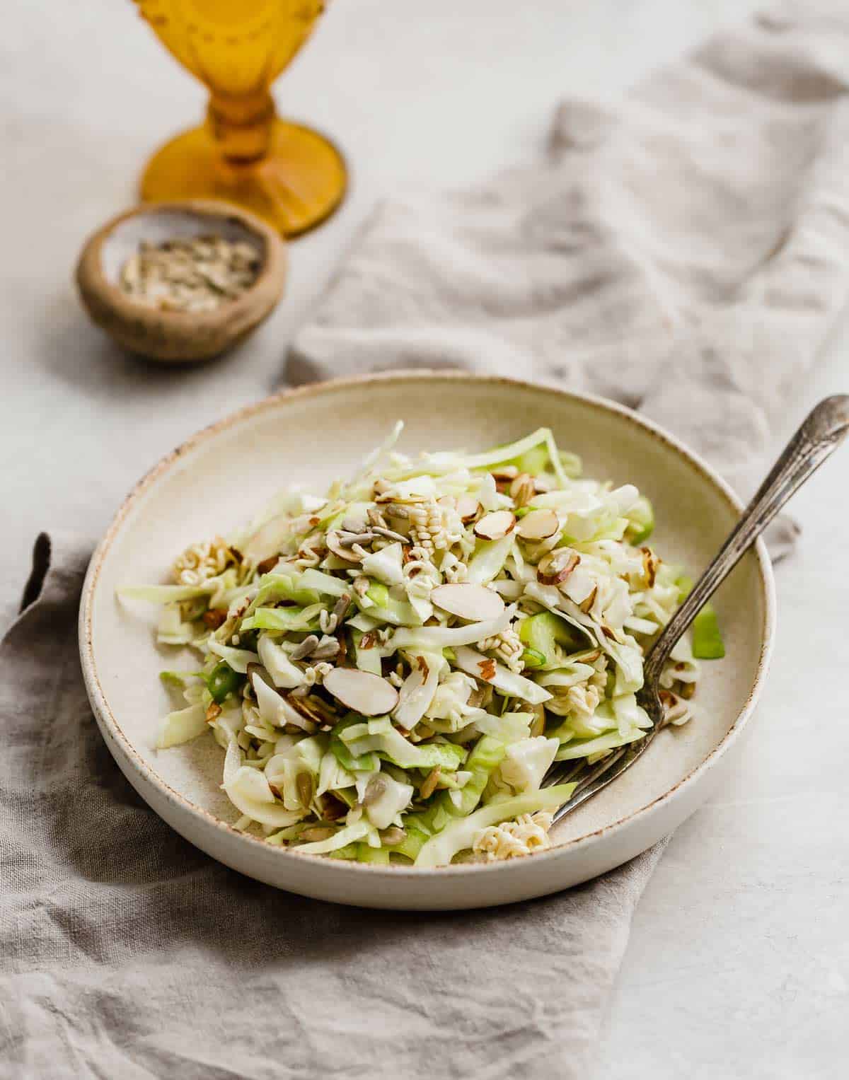 Crunchy Cabbage Salad recipe on a tan plate.