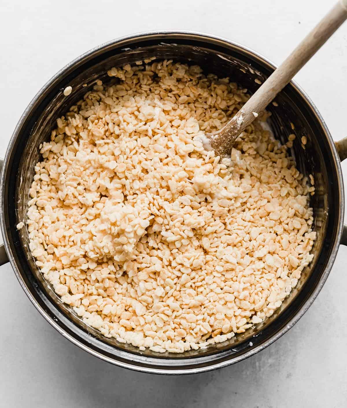 Rice Krispy cereal in a black pot, for making gooey Rice Krispies Treats.