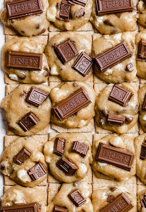 Close up photo of cookie dough disks topped with Hershey's chocolate bar pieces.