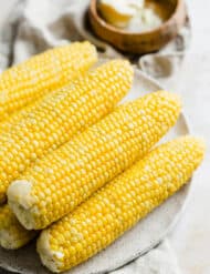 Husked corn on a plate.