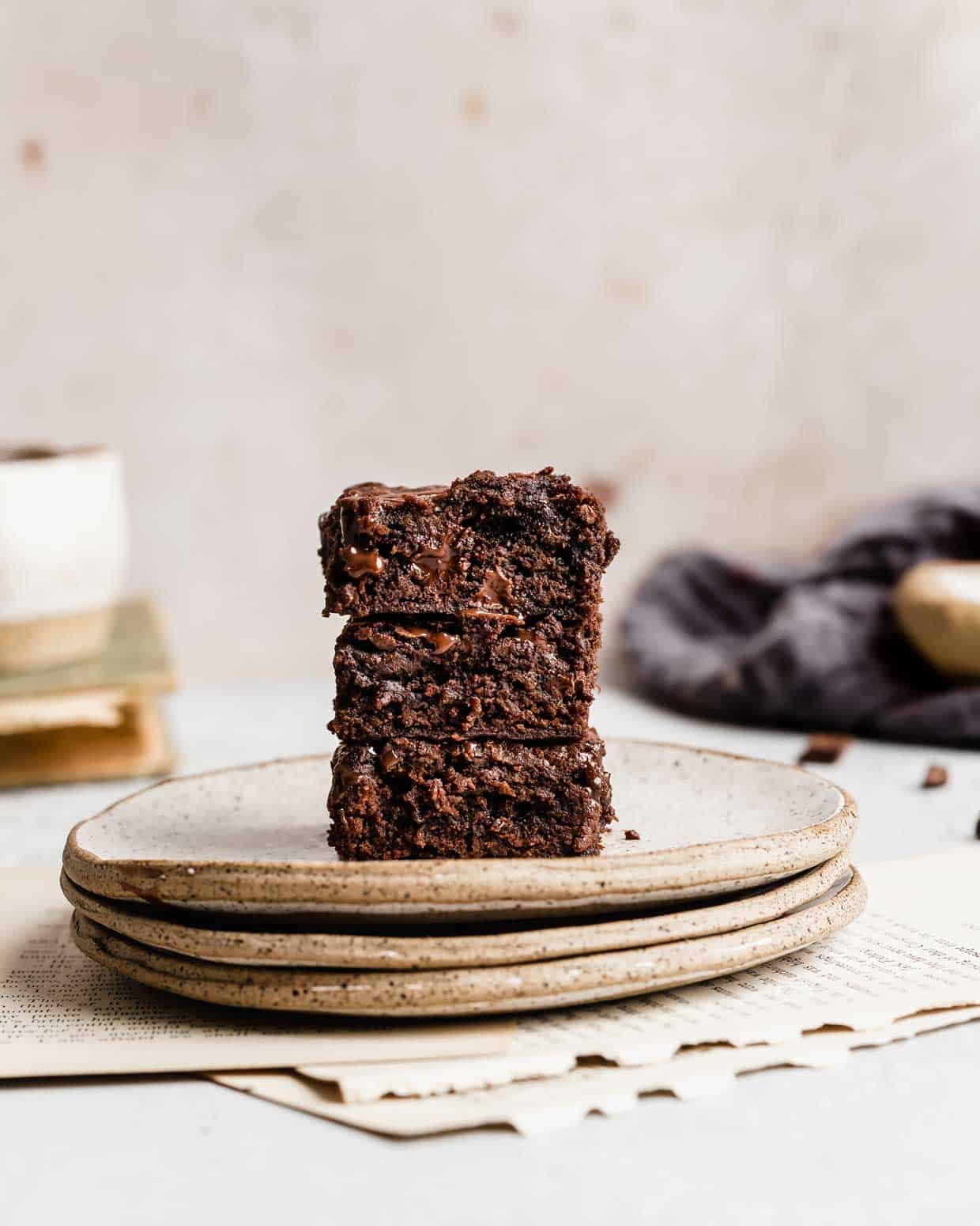 Three Homemade Brownies stacked on a plate.