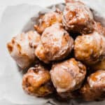 A pile of peach fritters on a plate.
